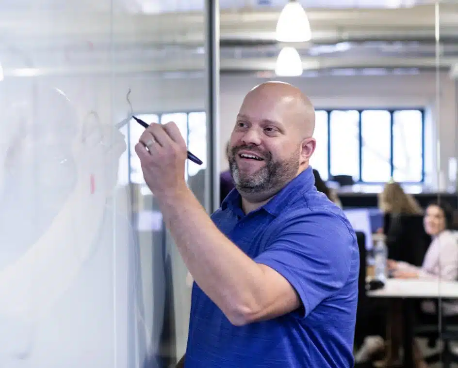 A man at a Whiteboard planning out Web Development Services and Web Design Services